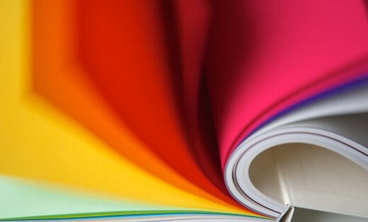 Colourful pages of paper swatch book flicking past