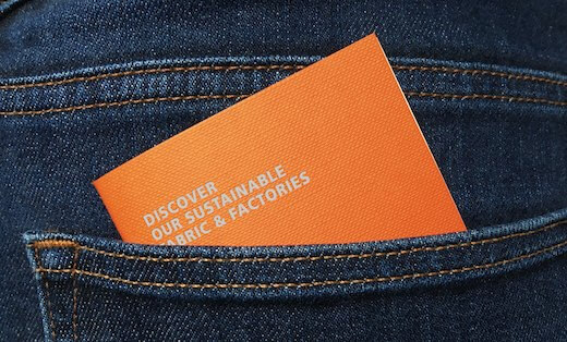 Small orange booklet in back pocket of blue jeans