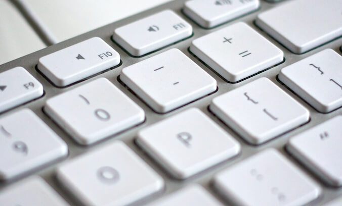 A computer keyboard showing the hyphen minus key