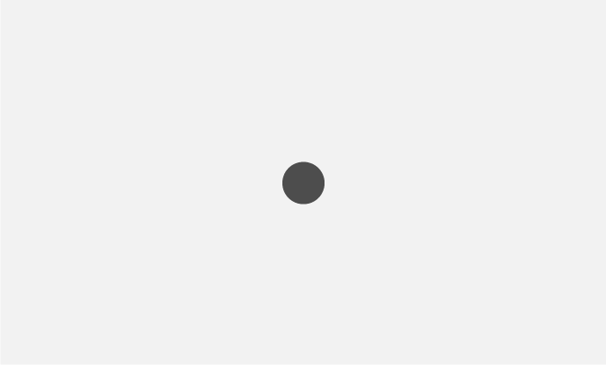 A single dark grey dot stands out in the centre of a pale grey background.