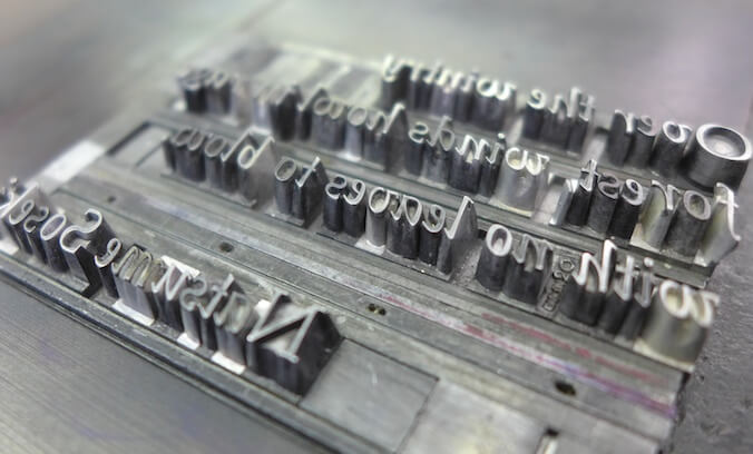 Italic moveable metal type locked up in a chase