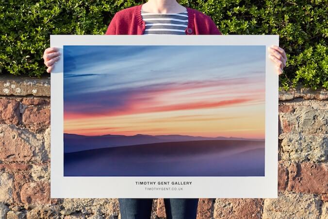 A large poster featuring a twilight photograph by Timothy Gent